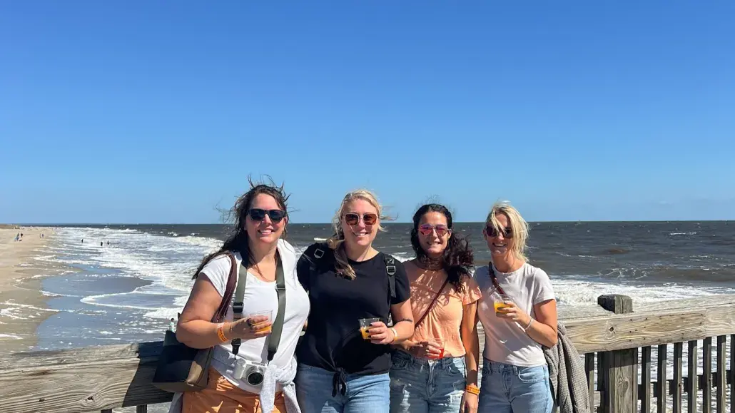 group of girls smiling on the pier