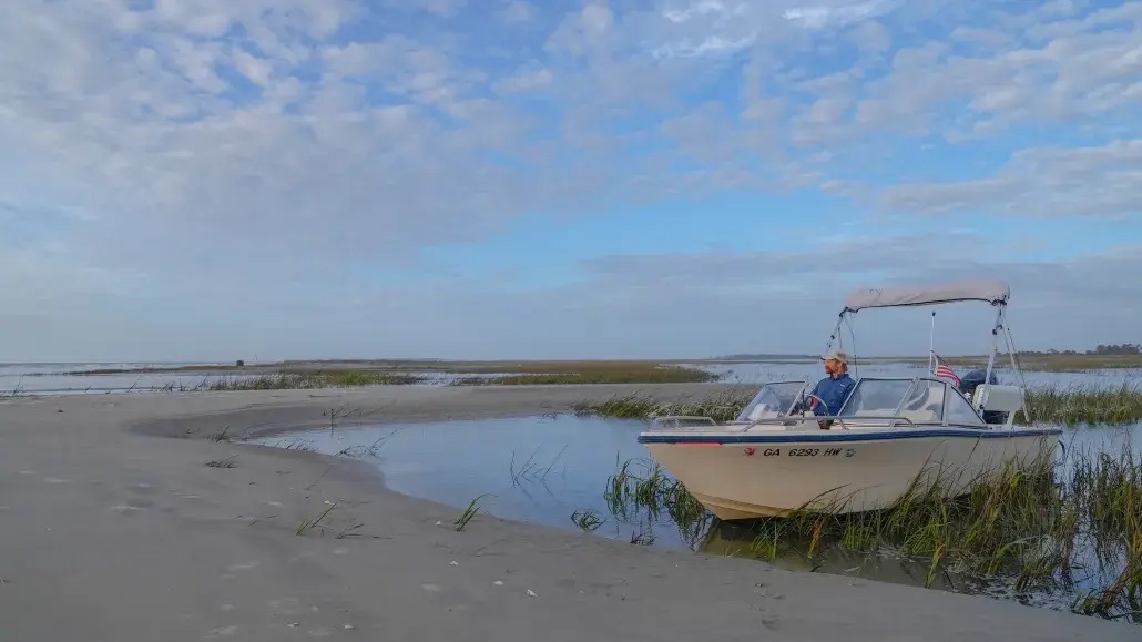 A boat captain sitting in a boat on the water of Tybee Island, GA.