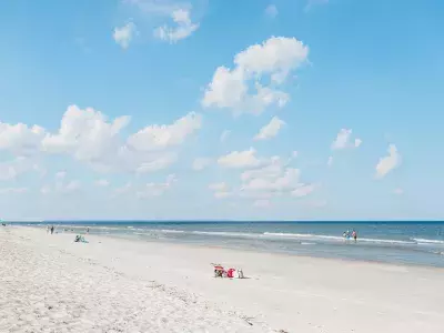 View of the beach, ocean and clear blue sky.