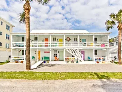 Exterior view of multiple condo units each with a bright colorful door