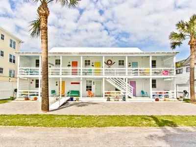 Exterior view of multiple condo units each with a bright colorful door