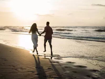 couple running on the beach