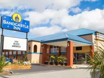 The exterior view of a hotel sign and its front entrance.