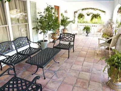 Outdoor balcony with black wrought iron seating