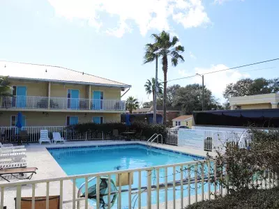 A large hotel pool with seating.