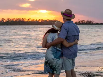 A couple watching the sunset on the beach