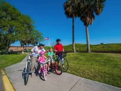 A family of four bike riding.