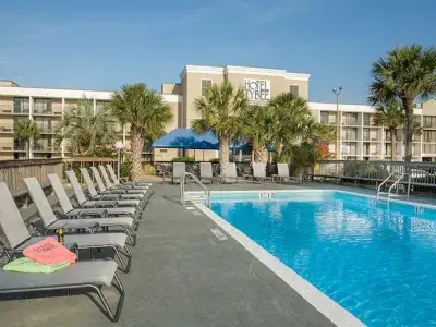 An outdoor hotel pool with seats around the pool.