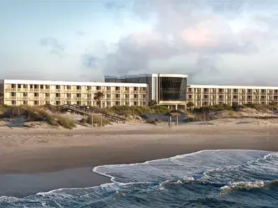 A oceanfront hotel on the beach.
