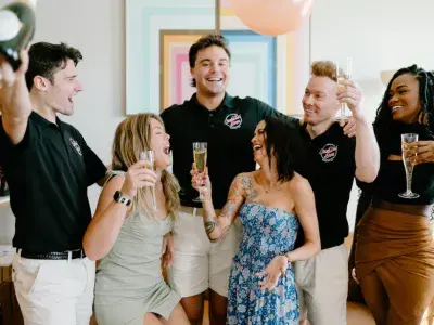 Men and women talking and laughing while drinking champagne
