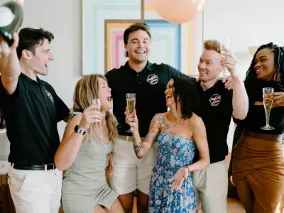 Men and women talking and laughing while drinking champagne