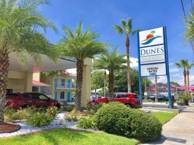 The exterior front view of a hotel and its sign.