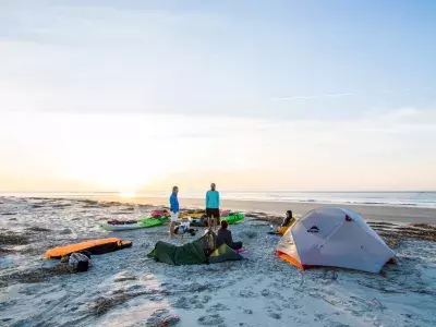 People camping on Little Tybee Island at sunset.