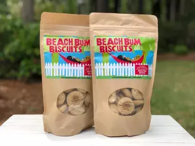 Two bags of dog treats sitting on a table with a white tablecloth.