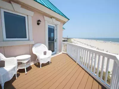 An outdoor deck with a beach view.