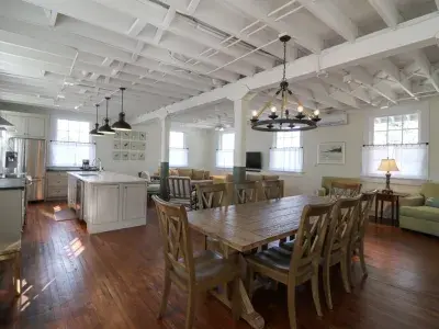A spacious open concept combining a living room, dining area and kitchen.