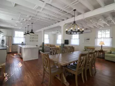 A spacious open concept combining a living room, dining area and kitchen.