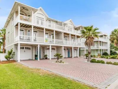 Exterior view of 59 Captain's View home on Tybee Island with a driveway and garage