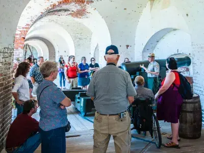 A guided group tour exploring the interior of Fort Pulaski.