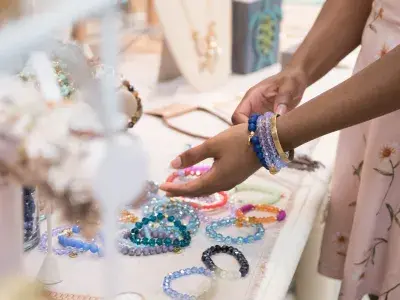 A person shopping for handmade jewelry.