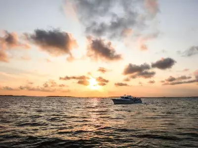 A boat on the water at sunset