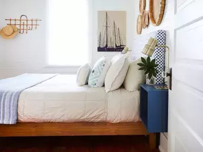 A view of a bed in a nautical-themed bedroom.