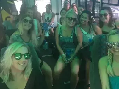 A large group of people on an island beach bus