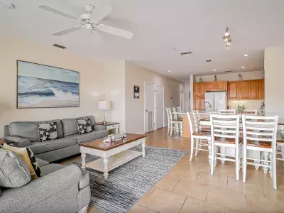 A living and dining room with a view of the kitchen.