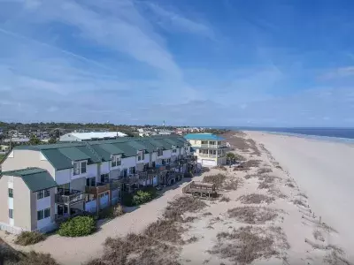 Aerial view of condo property on the beach on a sunny day with blue skies