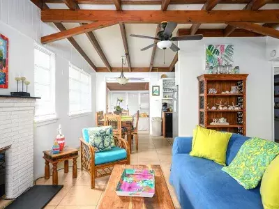 A spacious living room with bright colored furniture and a fireplace