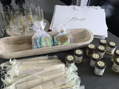 Souvenir gifts, champagne glasses and gift bags on a table.