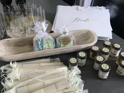 Souvenir gifts, champagne glasses and gift bags on a table.