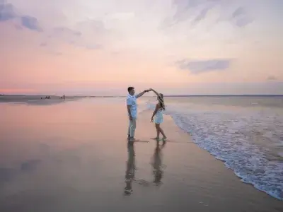 couple dancing on the beach at sunset