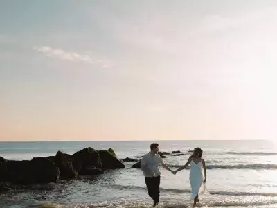 couple walking along the shore