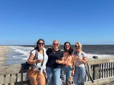 group of girls smiling on the pier