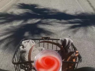 Bike riding with a cold drink in the handle basket.
