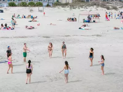 A large crowd of people on the beach.