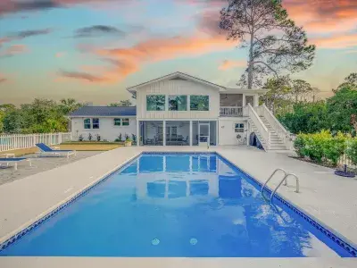 A secluded coastal cottage with an outdoor pool, by Tybee Cottages.
