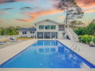 A secluded coastal cottage with an outdoor pool, by Tybee Cottages.