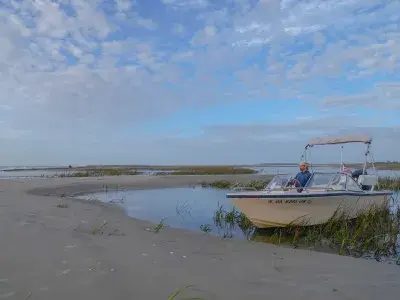 A boat captain sitting in a boat on the water of Tybee Island, GA.