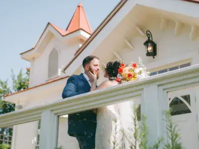 Bride and groom embrace on the porch of The Chapel by the Sea on Tybee Island.