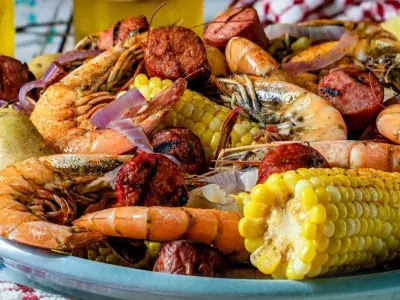 A lowcountry boil served on a blue plate.