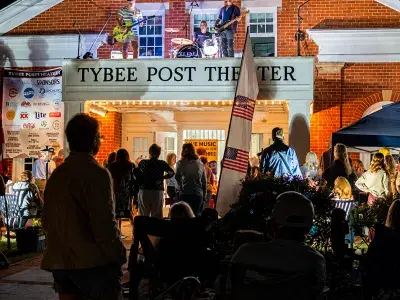 Crowd gathers outside the Tybee Post Theater for an evening performance during the Tybee Post Music Festival Lawn Party.