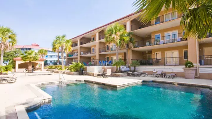 An exterior condominium view and outdoor pool