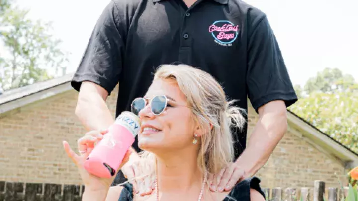 A man massaging a woman’s shoulders.