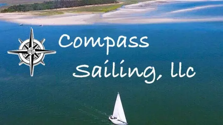 Compass Sailing logo - aerial view of a sailboat on the ocean.