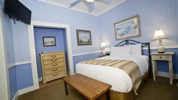 A full-size bedroom with ocean blue walls.