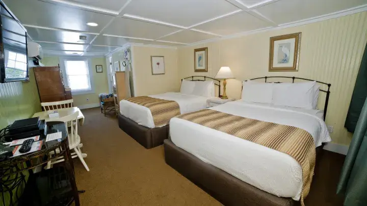 Two double beds in a room.