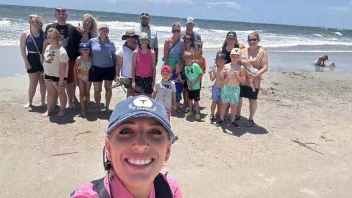 A group photo on Tybee Island beach with Tybee Shark Teeth Tours