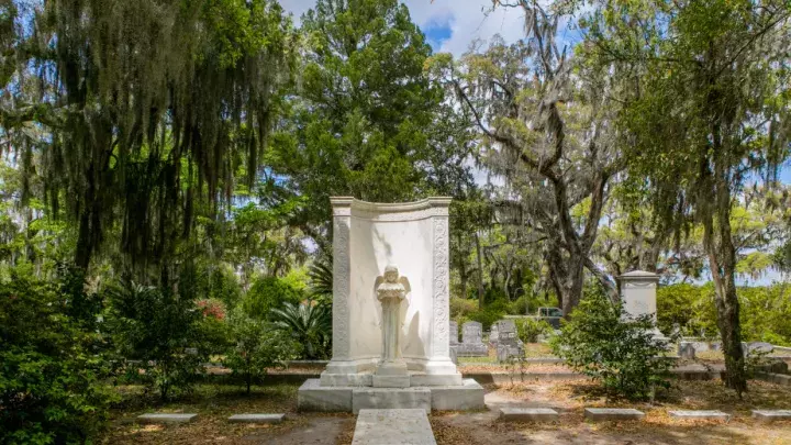 A large white tomb in a cemetary